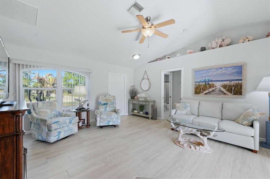 4036 Elvington Road Port Charlotte, FL 33981 - Photo 17 of 29 a living room with furniture and wooden floor