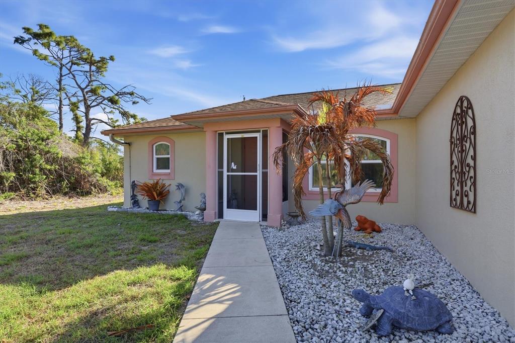 4036 Elvington Road Port Charlotte, FL 33981 - Photo 2 of 29 a front view of a house with garden