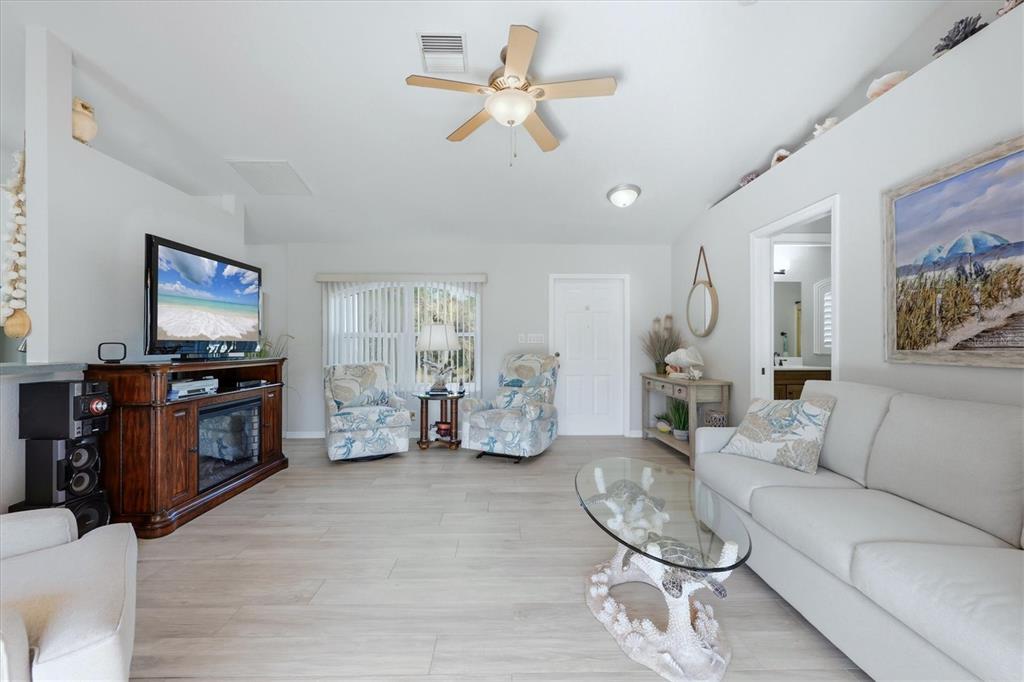 4036 Elvington Road Port Charlotte, FL 33981 - Photo 22 of 29 a living room with furniture and a flat screen tv
