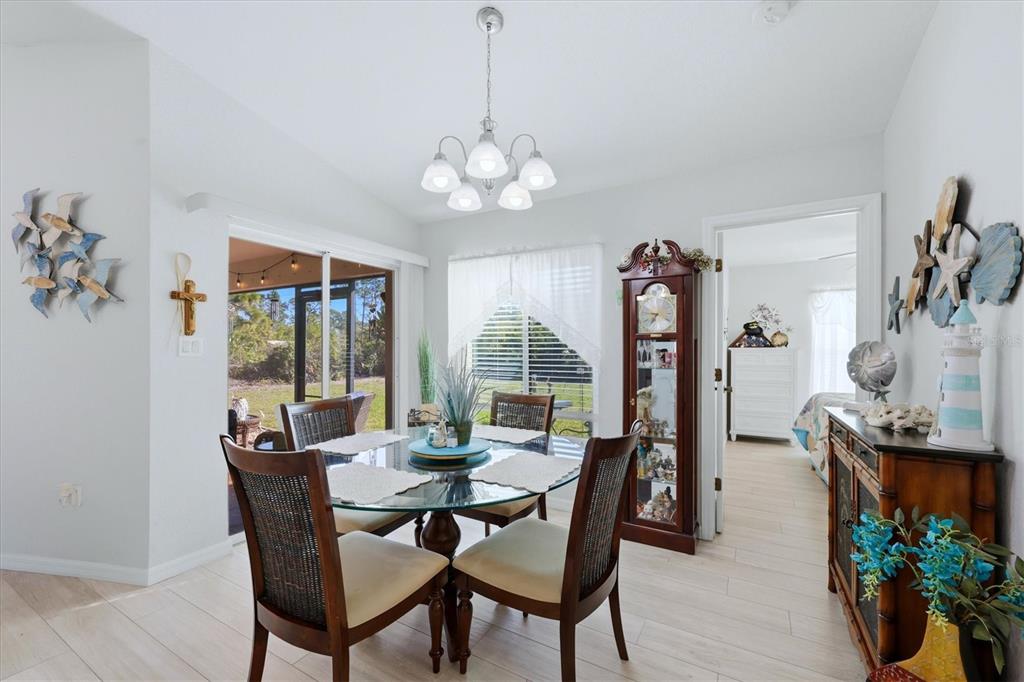 4036 Elvington Road Port Charlotte, FL 33981 - Photo 23 of 29 a view of a dining room with furniture window and wooden floor