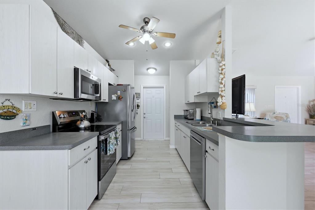 4036 Elvington Road Port Charlotte, FL 33981 - Photo 24 of 29 a kitchen with stainless steel appliances granite countertop a sink and stove
