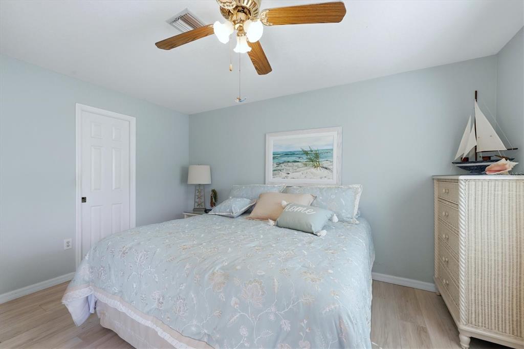 4036 Elvington Road Port Charlotte, FL 33981 - Photo 29 of 29 a bedroom with a bed and a chandelier