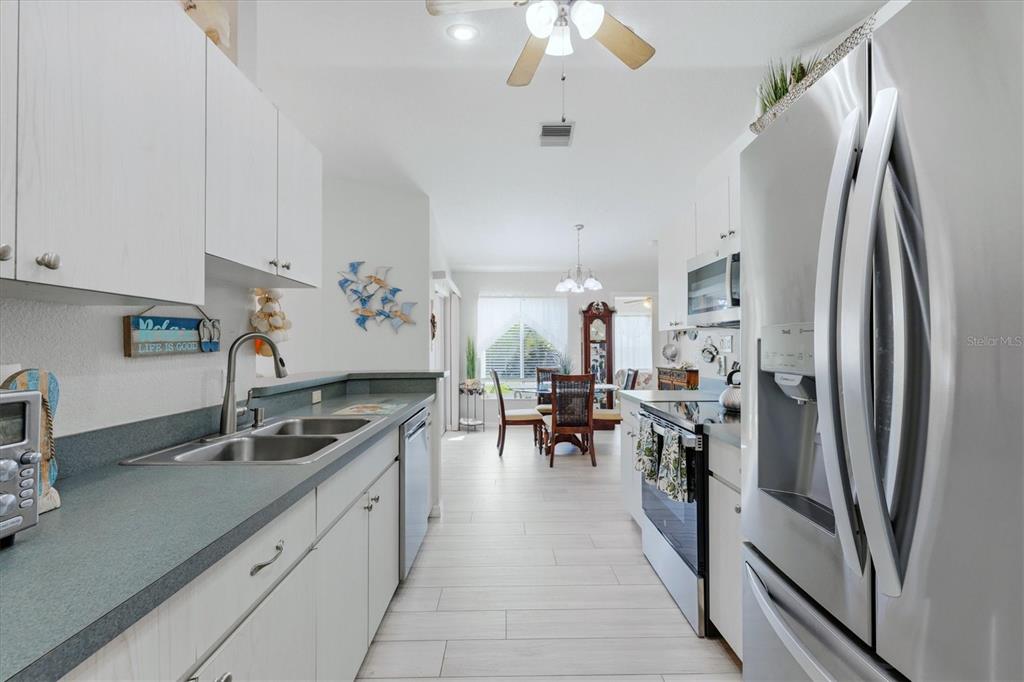 4036 Elvington Road Port Charlotte, FL 33981 - Photo 6 of 29 a kitchen with stainless steel appliances granite countertop a refrigerator and a sink