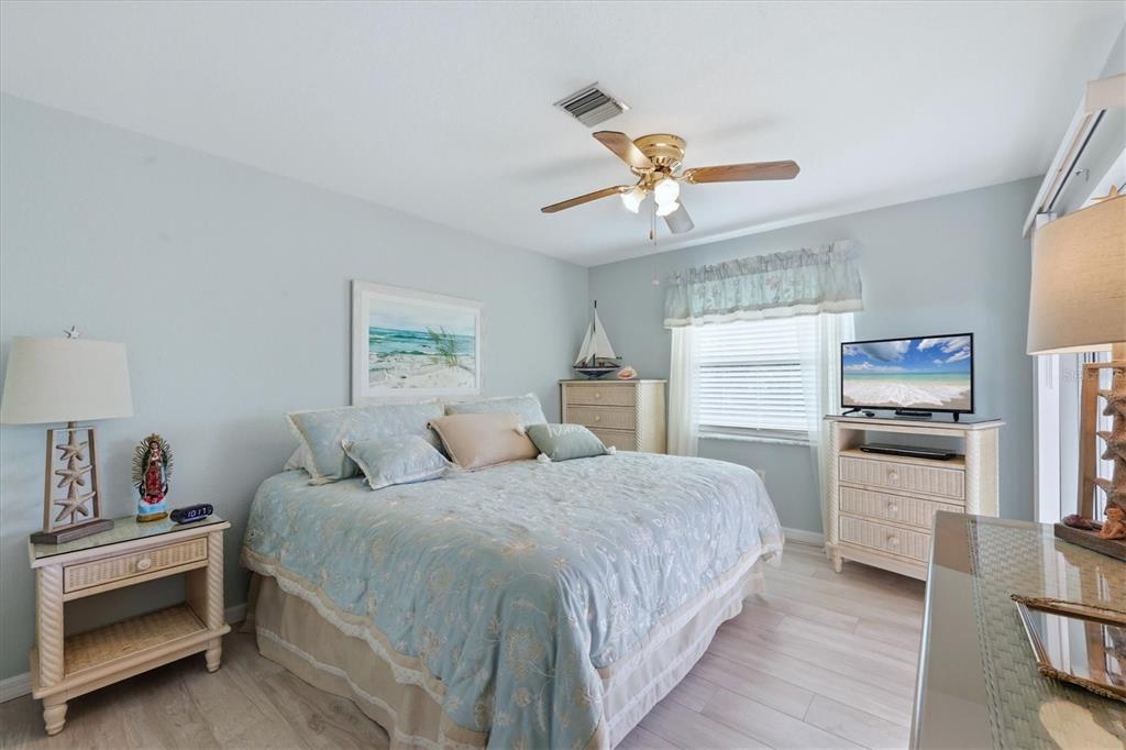 4036 Elvington Road Port Charlotte, FL 33981 - Photo 7 of 29 a bedroom with a bed and a chandelier
