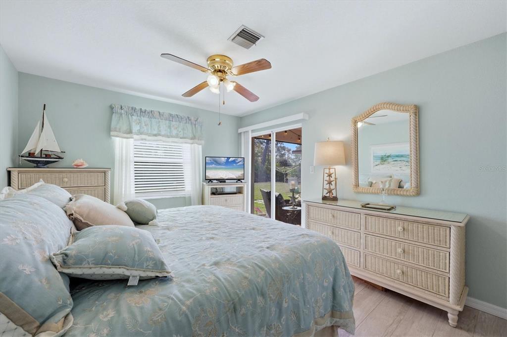 4036 Elvington Road Port Charlotte, FL 33981 - Photo 8 of 29 a bedroom with a large bed and a window
