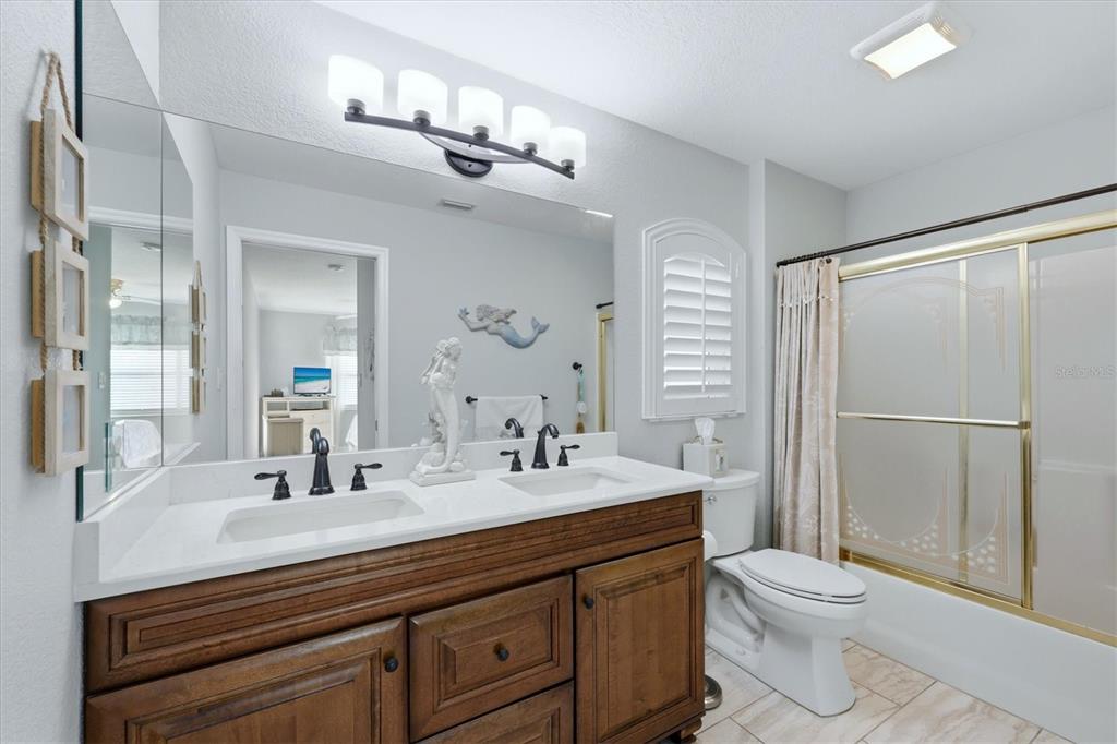 4036 Elvington Road Port Charlotte, FL 33981 - Photo 9 of 29 a bathroom with a double vanity sink toilet and shower
