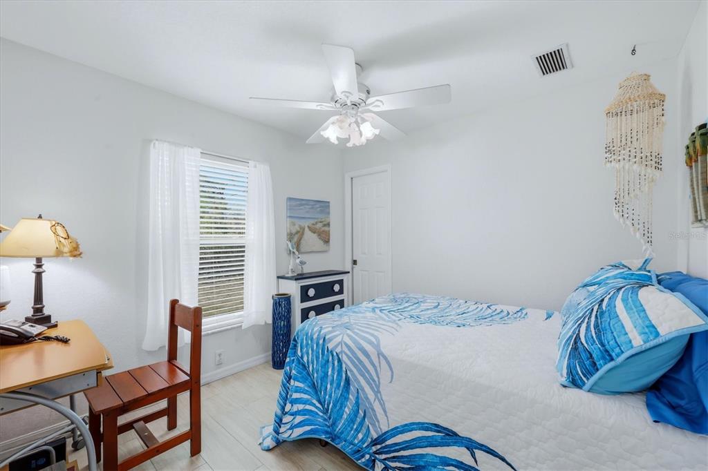 4036 Elvington Road Port Charlotte, FL 33981 - Photo 10 of 29 a bedroom with a bed and a chandelier