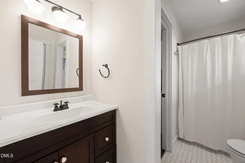 a bathroom with a sink vanity and a mirror