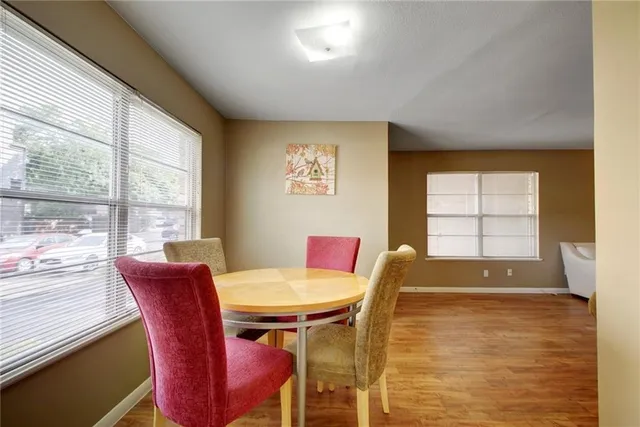 a view of a dining room with furniture and wooden floor