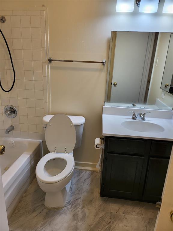 6900 Skillman Street, Unit 111 Dallas, TX 75231 - Photo 15 of 25 a bathroom with a sink a toilet and shower