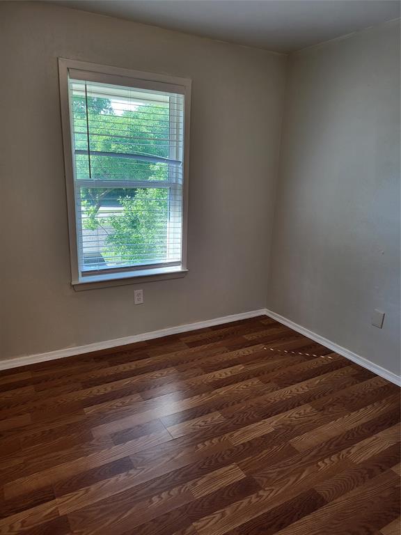 6900 Skillman Street, Unit 111 Dallas, TX 75231 - Photo 16 of 25 a view of a room with wooden floor and window