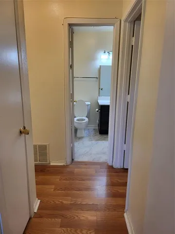 a view of a bathroom from a hallway