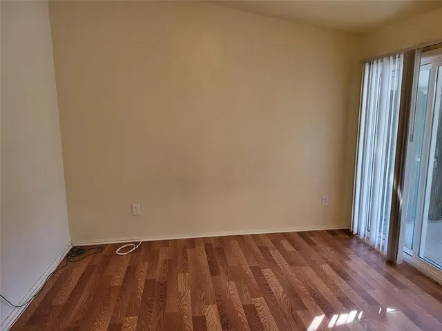 a view of an empty room and wooden floor