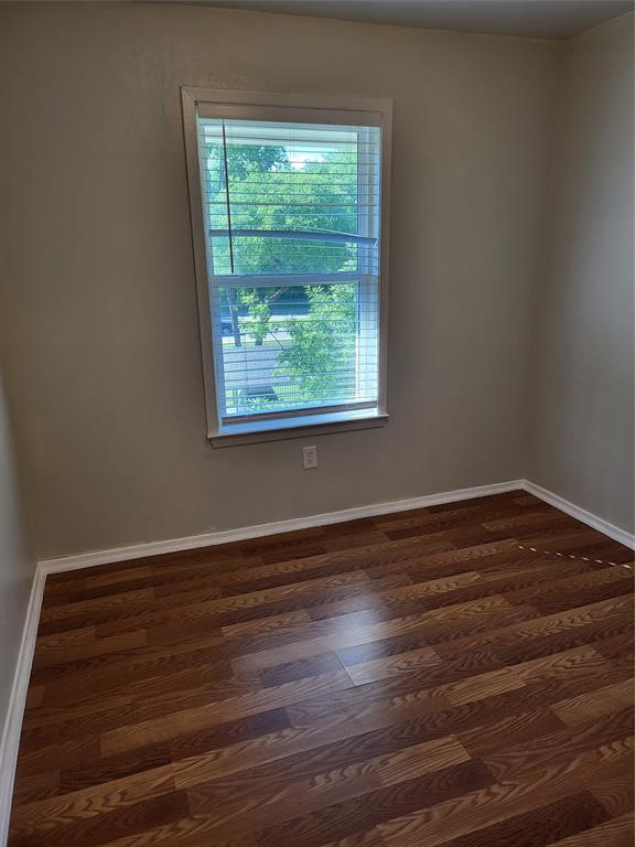 6900 Skillman Street, Unit 111 Dallas, TX 75231 - Photo 24 of 25 a view of an empty room with wooden floor and a window