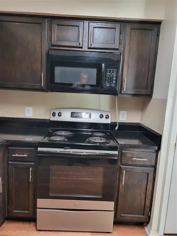 a stove top oven sitting inside of a kitchen