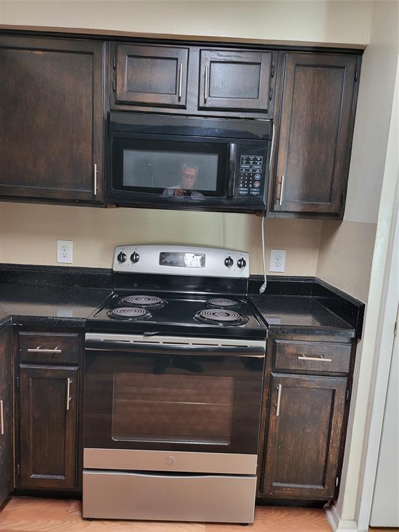 6900 Skillman Street, Unit 111 Dallas, TX 75231 - Photo 7 of 25 a stove top oven sitting inside of a kitchen