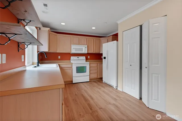 a kitchen with stainless steel appliances a refrigerator and a stove top oven