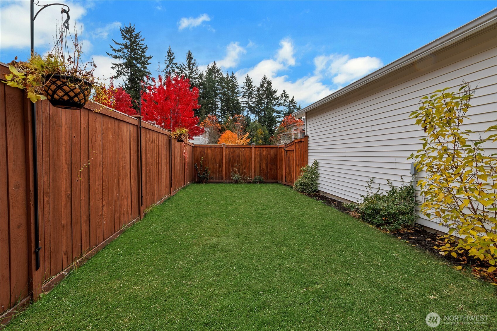 1285 Griggs Street DuPont, WA 98327 - Photo 15 of 23 a view of a backyard with potted plants and wooden fence