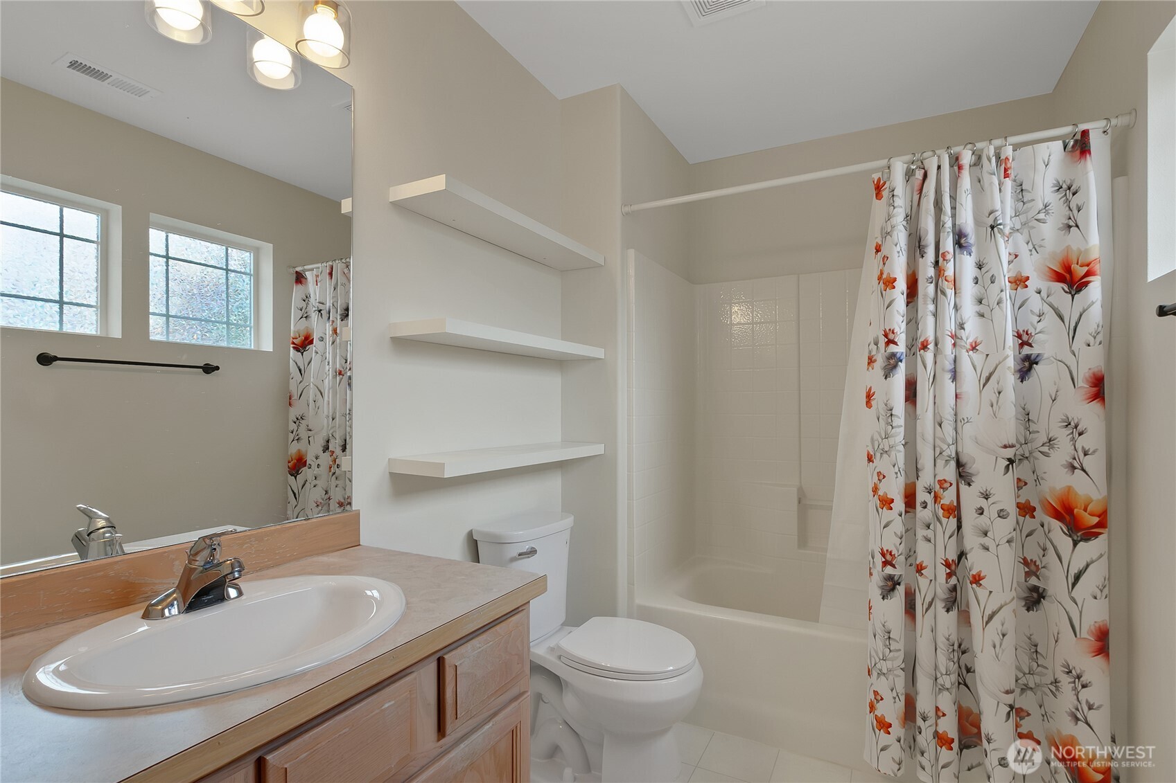 1285 Griggs Street DuPont, WA 98327 - Photo 23 of 23 a bathroom with a sink toilet and shower