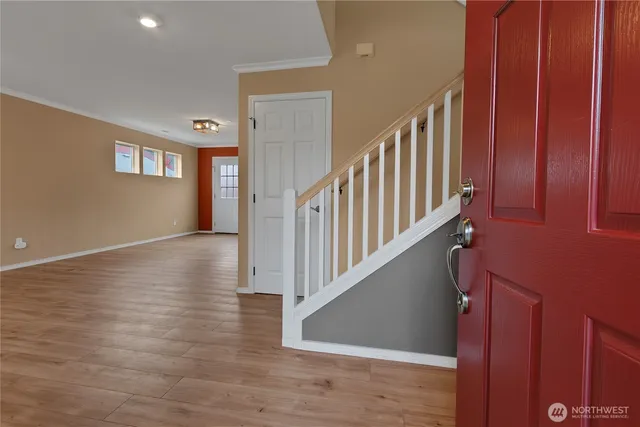 a view of an entryway with wooden floor