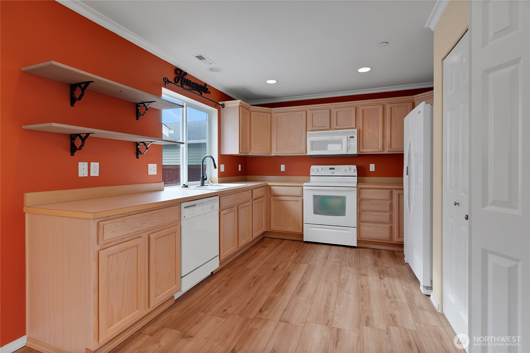 1285 Griggs Street DuPont, WA 98327 - Photo 10 of 23 a kitchen with stainless steel appliances granite countertop a sink cabinets and wooden floor