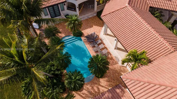 a swimming pool with outdoor seating and yard