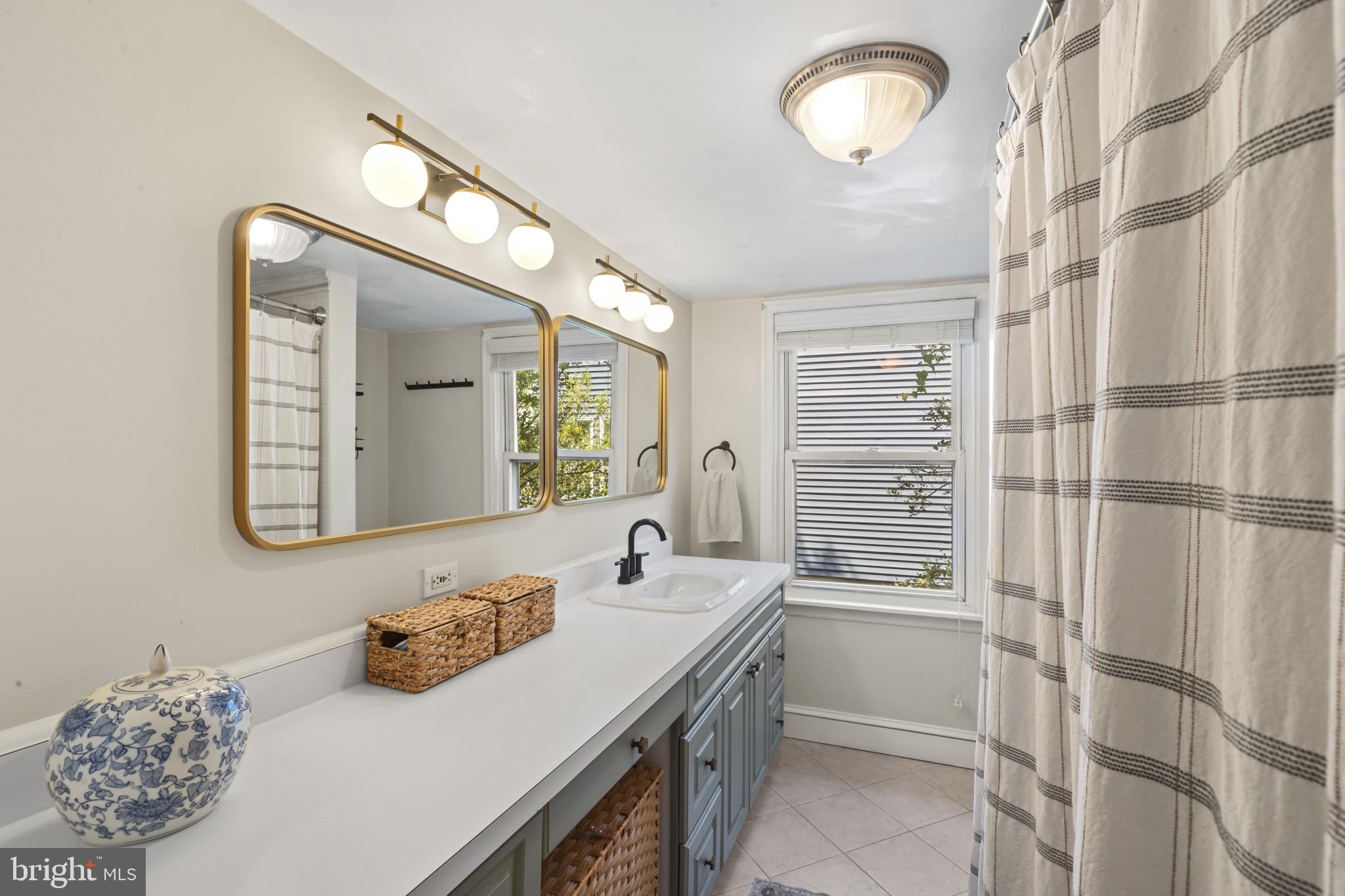 6500 Sharon Road Baltimore, MD 21239 - Photo 22 of 33 a bathroom with a sink vanity and a mirror