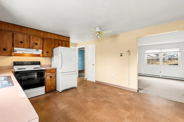 a kitchen with a refrigerator stove and cabinets