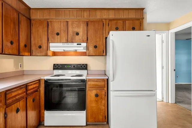 a kitchen with stainless steel appliances granite countertop a refrigerator stove a sink and dishwasher