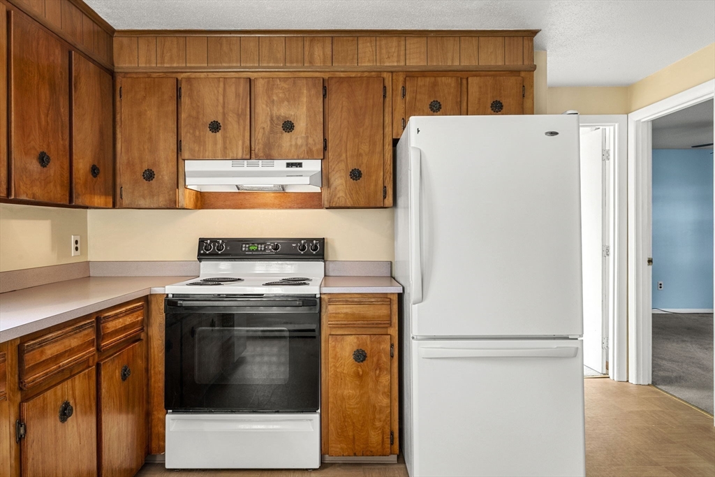3 Wysocki Drive, Unit 6 Dudley, MA 01571 - Photo 13 of 24 a kitchen with stainless steel appliances granite countertop a refrigerator stove a sink and dishwasher