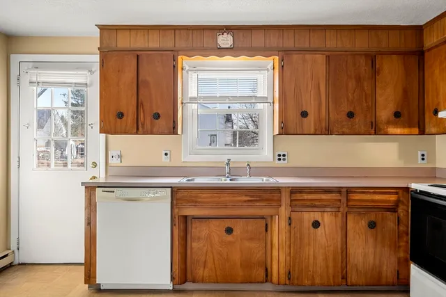 a kitchen with stainless steel appliances granite countertop a sink and cabinets with wooden floor