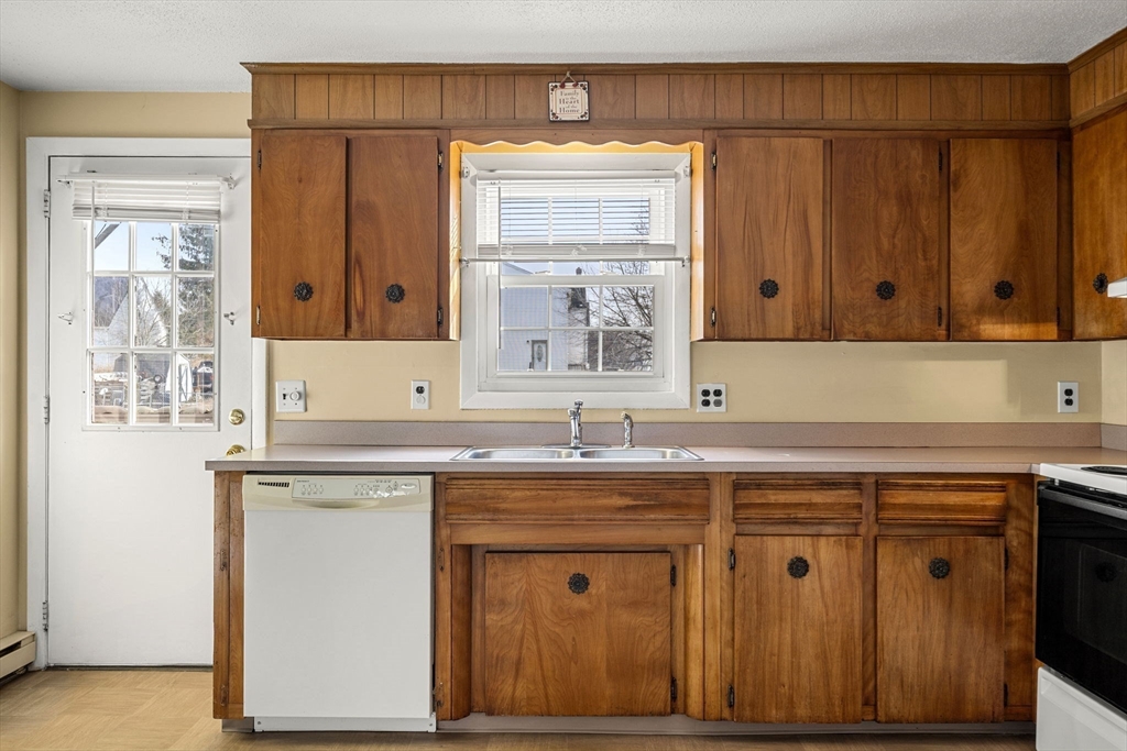 3 Wysocki Drive, Unit 6 Dudley, MA 01571 - Photo 14 of 24 a kitchen with stainless steel appliances granite countertop a sink and cabinets with wooden floor