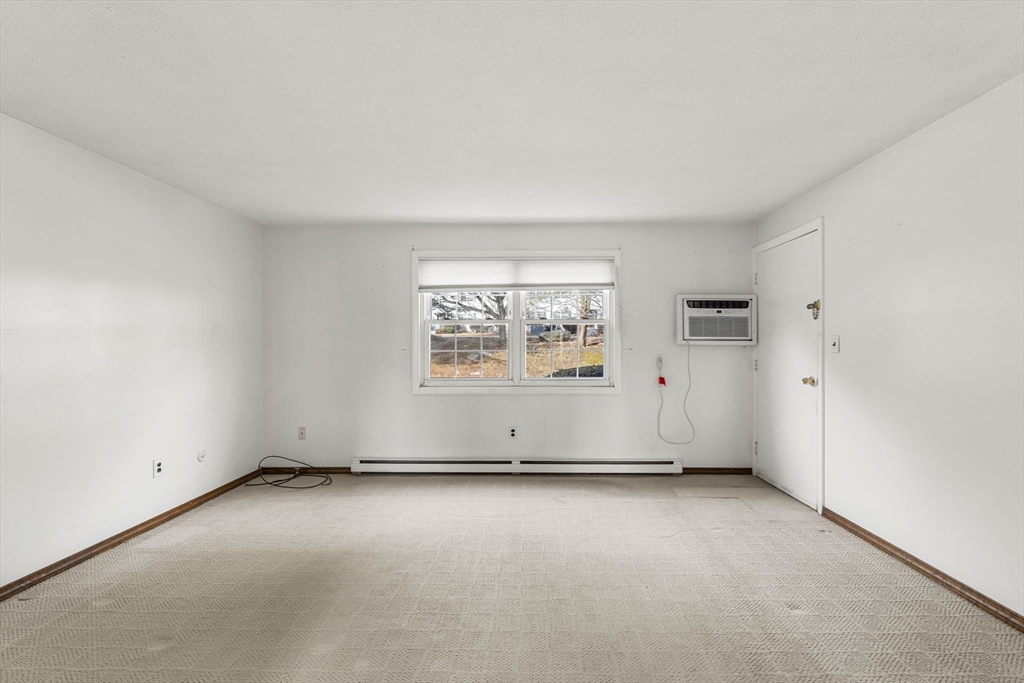 3 Wysocki Drive, Unit 6 Dudley, MA 01571 - Photo 17 of 24 an empty room with windows