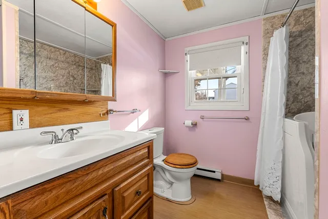 a bathroom with a sink toilet and window