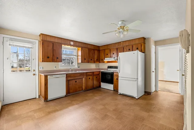 a kitchen with a refrigerator sink stove and cabinets