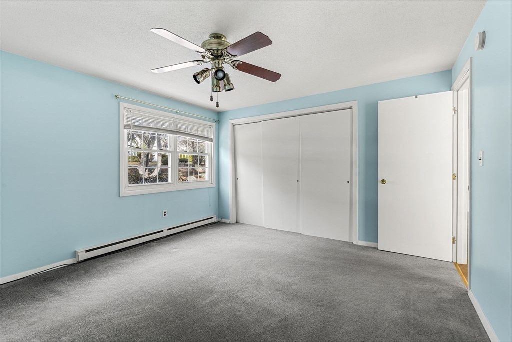 3 Wysocki Drive, Unit 6 Dudley, MA 01571 - Photo 5 of 24 an empty room with windows and fan