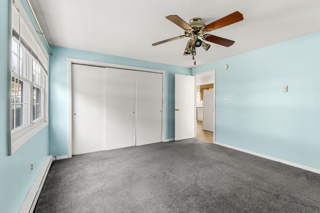 3 Wysocki Drive, Unit 6 Dudley, MA 01571 - Photo 6 of 24 an empty room with fan and windows