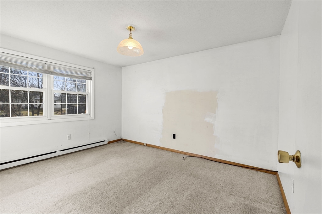 3 Wysocki Drive, Unit 6 Dudley, MA 01571 - Photo 7 of 24 an empty room with a window