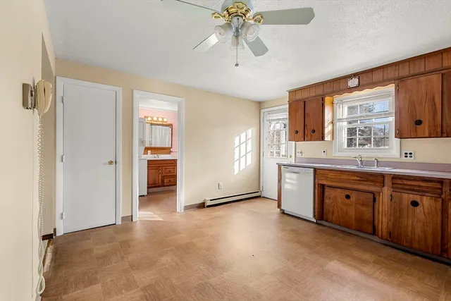 a spacious bathroom with a granite countertop sink and a mirror