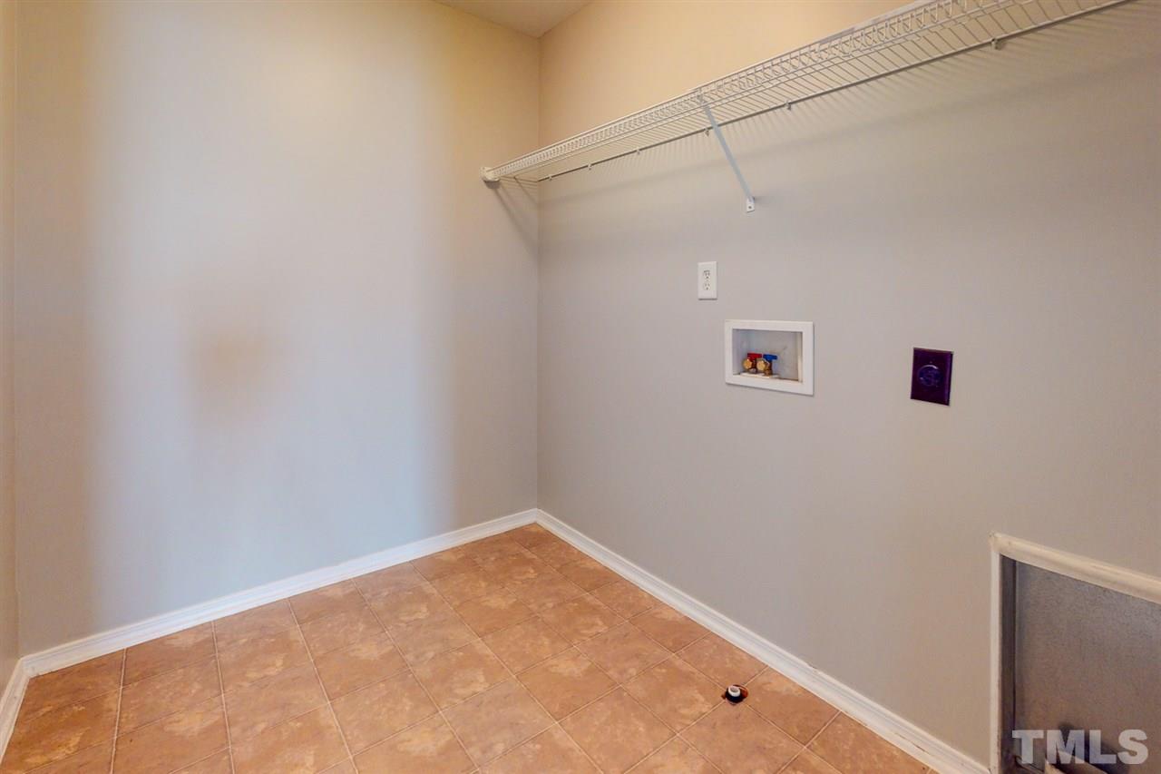 8504 Slabstone Court Raleigh, NC 27613 - Photo 26 of 30 Large laundry room on the second floor and convenient to all bedrooms.