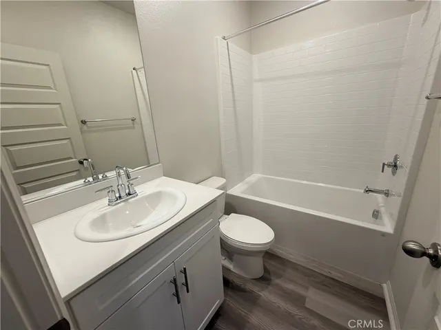 a bathroom with a sink toilet a mirror and shower