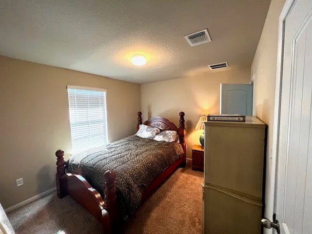 a bedroom with a bed and dresser