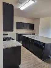 a kitchen with a sink and a stove top oven