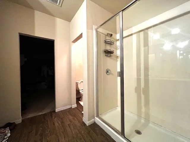 a bathroom with a glass shower door