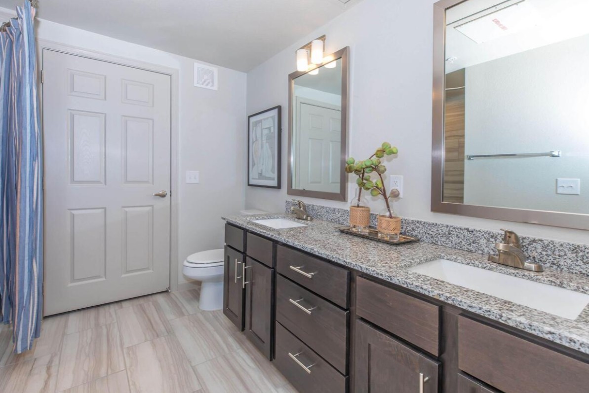 907 S Road, Unit 7202 Baytown, TX 77521 - Photo 12 of 12 a bathroom with a granite countertop sink and a mirror
