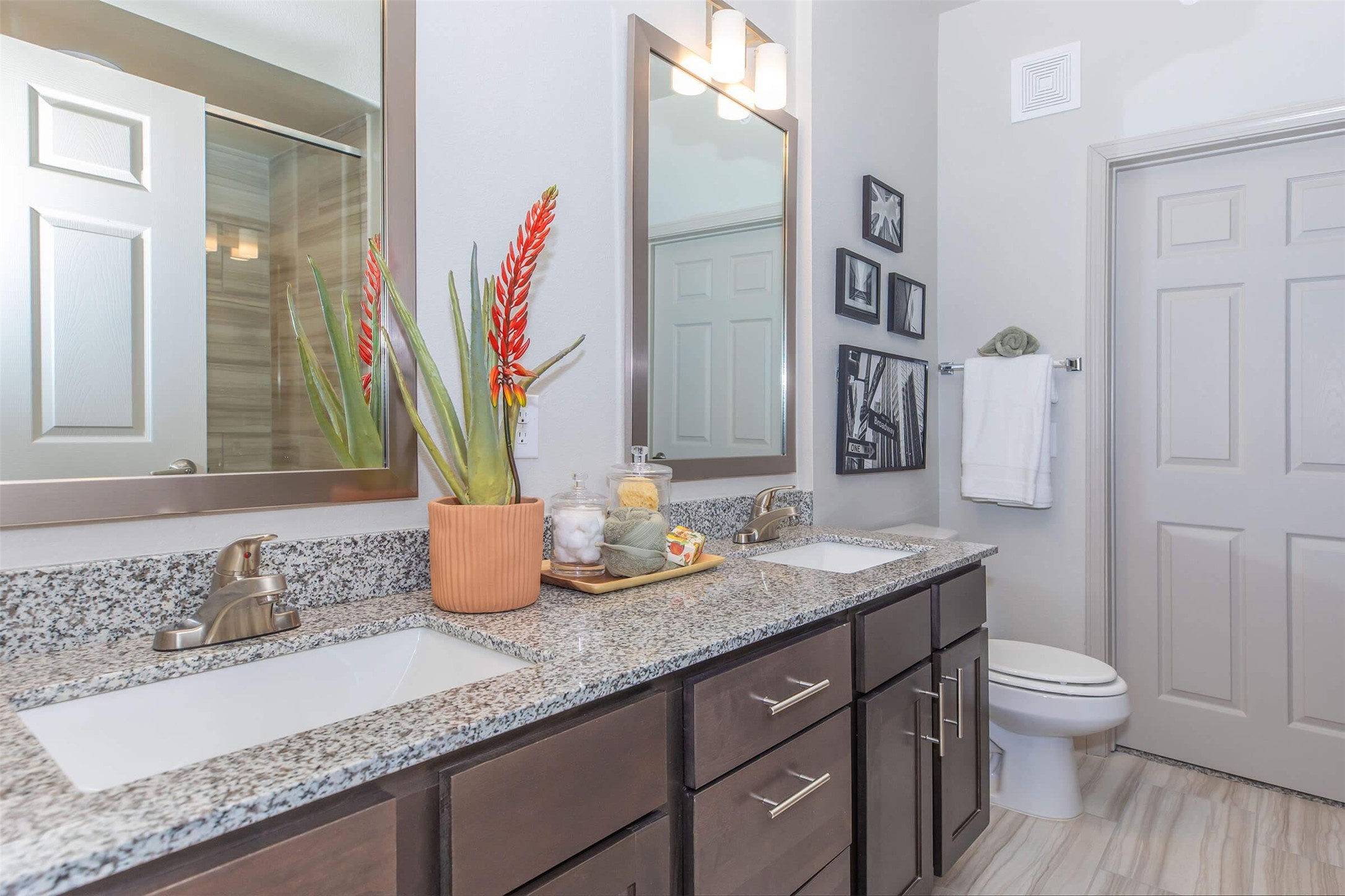 907 S Road, Unit 7202 Baytown, TX 77521 - Photo 3 of 12 a bathroom with a granite countertop sink a toilet and a mirror