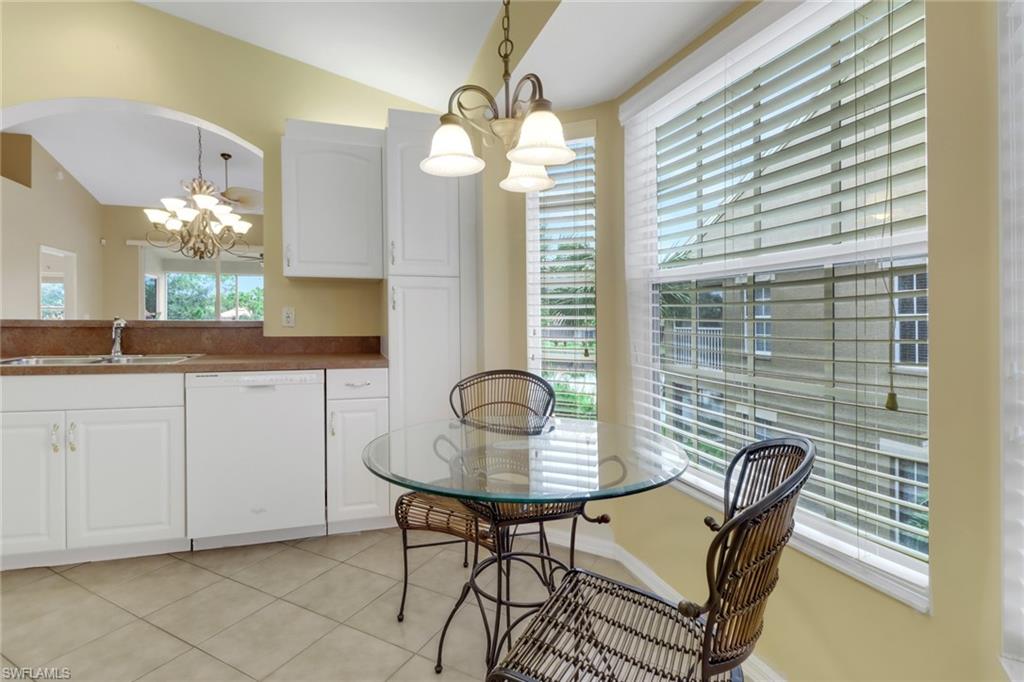 20141 Seagrove Street, Unit 308 Estero, FL 33928 - Photo 15 of 36 a view of a dining room with furniture and chandelier