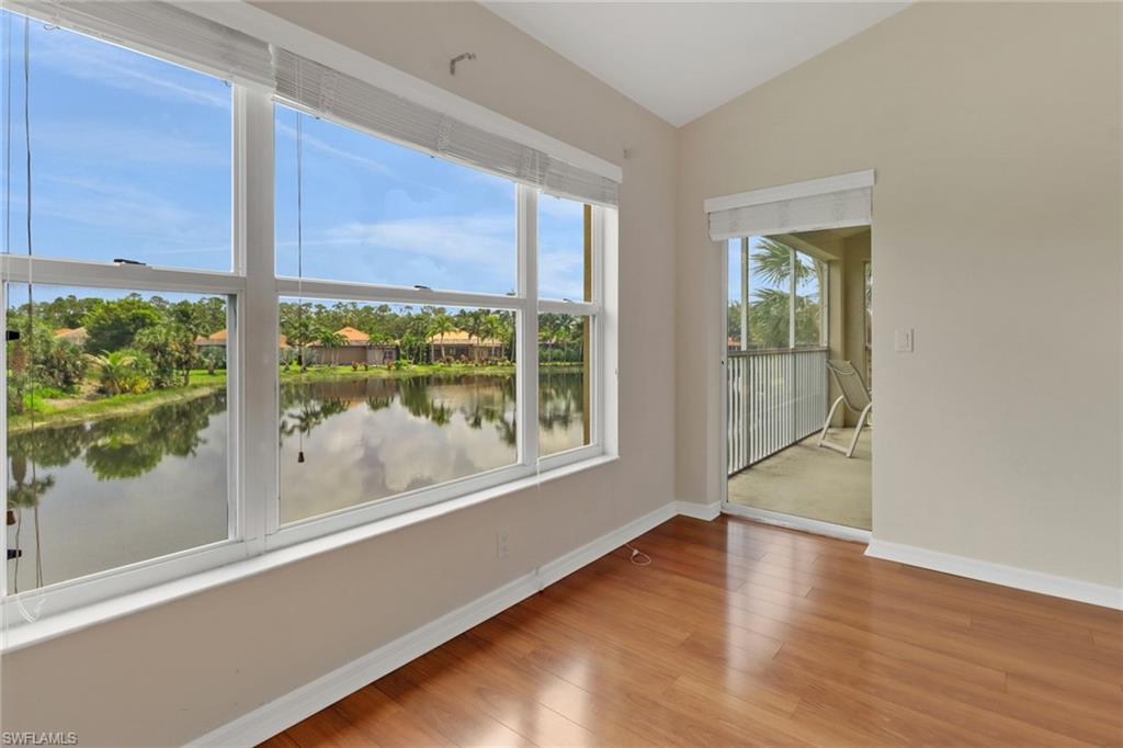 20141 Seagrove Street, Unit 308 Estero, FL 33928 - Photo 22 of 36 a view of an empty room with a window and wooden floor