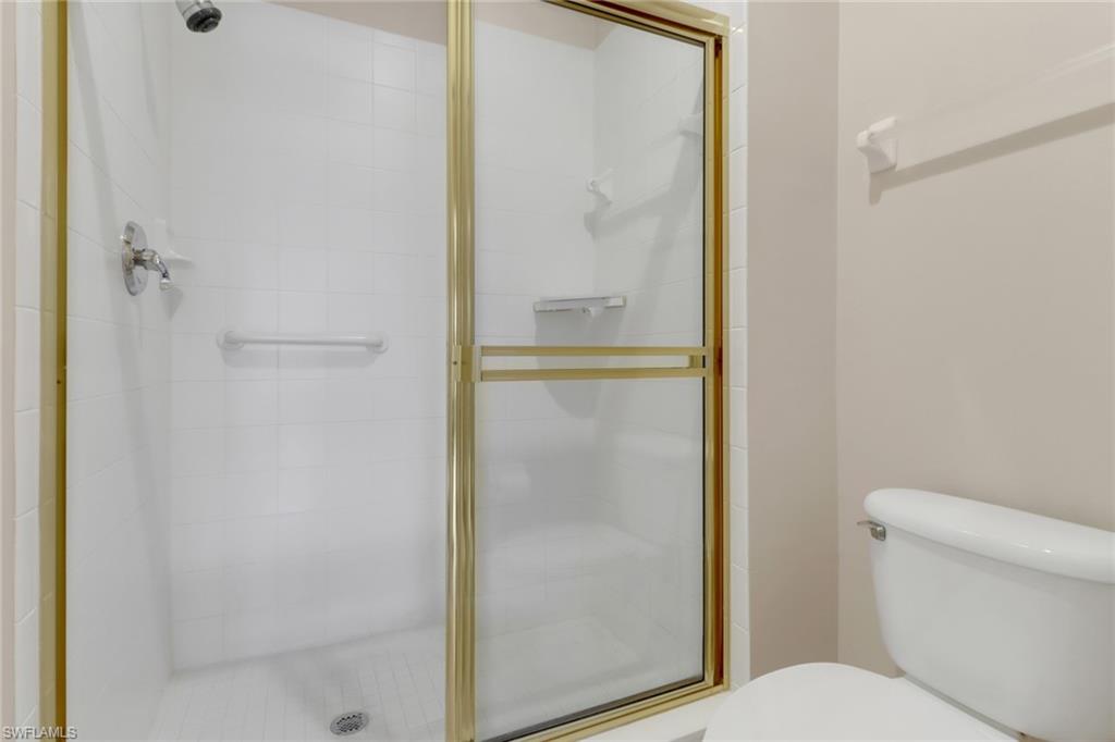20141 Seagrove Street, Unit 308 Estero, FL 33928 - Photo 24 of 36 a bathroom with a glass shower door