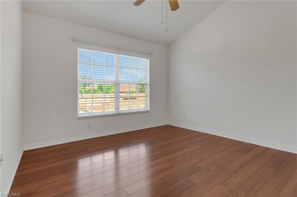 20141 Seagrove Street, Unit 308 Estero, FL 33928 - Photo 26 of 36 an empty room with wooden floor and windows